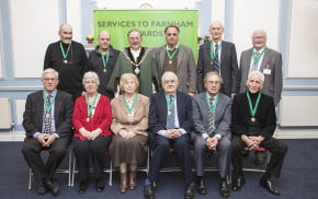 10 males and 2 females sitting after receiving awards.