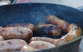 Cooking sausages. Frying pan.