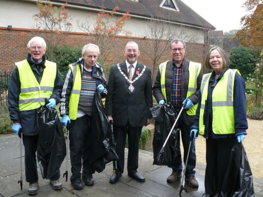 The Mayor and four councillors with black rubbish sacks and litter pickers.