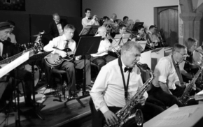 Black and white photo of band members playing musical instruments