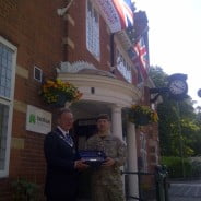 Mayor and soldier outside council offices.