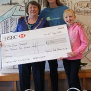 Three people including the Mayor with a large cheque.