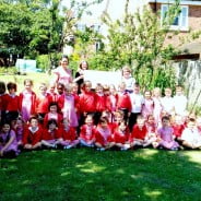 Large group of children and the Mayor in garden.