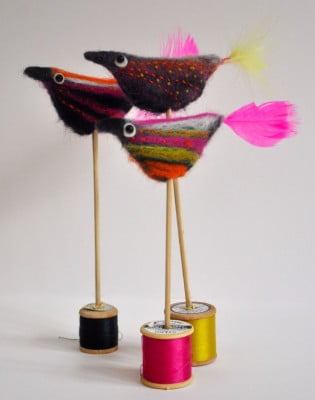 knitted birds on different coloured thread wheels.