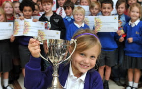 group of children holding awards.