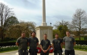 Five males in front of war memorial