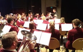 A group of children and adults playing musical instruments