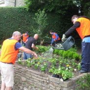 Six males gardening raised beds.