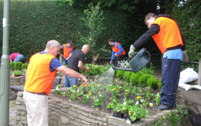 Six males gardening raised beds.