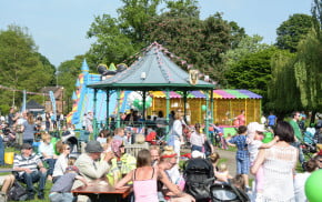 Crowds watching a band perform in the park