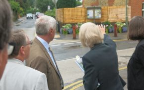 Judges looking at a garden area in a street.