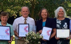 Group of people holding certificates.