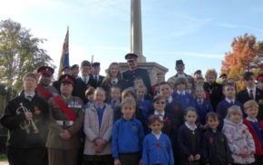 Group of children in front of war memorial