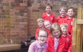 School children by a gate.