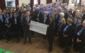 Group of people and the Mayor holding a large cheque.