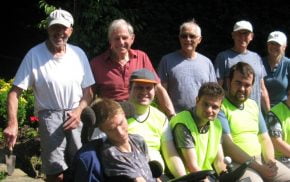 Group of people sitting in a garden.