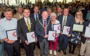 Group of people holding certificates.