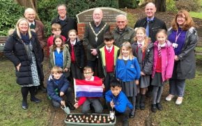 Schoolchildren with Dutch flag and container of tulip bulbs