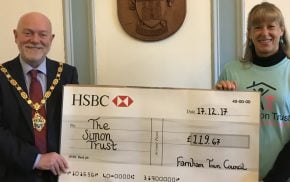 Mayor presents large cheque to a female representing The Simon Trust charity.