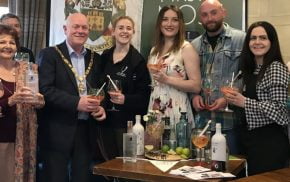 Group of people holding gin glasses.