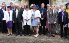 Group of people in smart clothing outside a church.