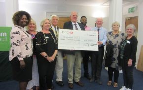 Group of people with a large cheque