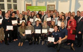 Group of people holding certificates.