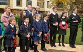 School children holding poppy wreaths