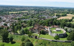 Aerial photo showing castle and green spaces and trees.