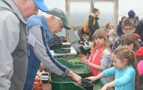 Adults and children gardening