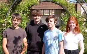 Four young people in a garden.