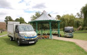 Electric vehicles parked either side of a bandstand