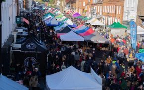 Aerial view of crowded street market and colourful marquees