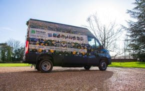 Van wrapped in floral vinyl and parked on gravel