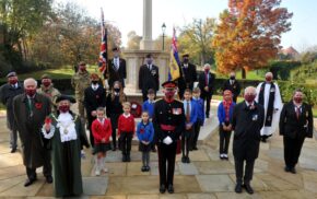School children, the Mayor and others socially distance at the war memorial.