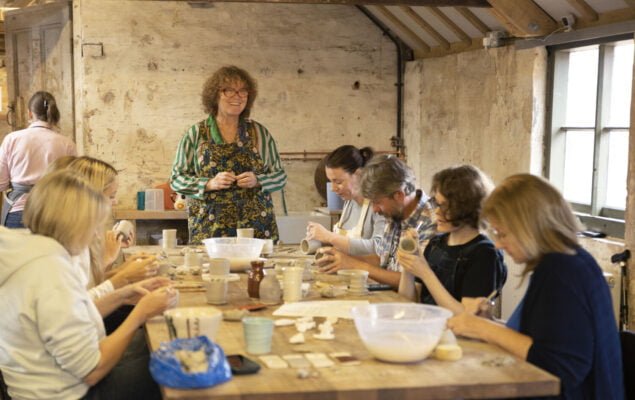 People sitting at a table doing a craft activity