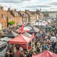 Picture of many food stalls and lots of people around them