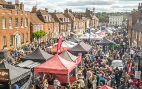 Picture of many food stalls and lots of people around them