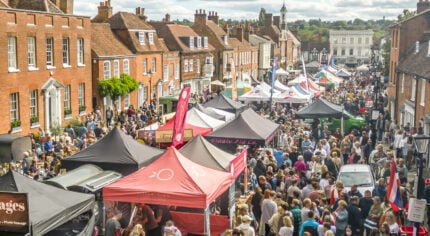 Picture of many food stalls and lots of people around them