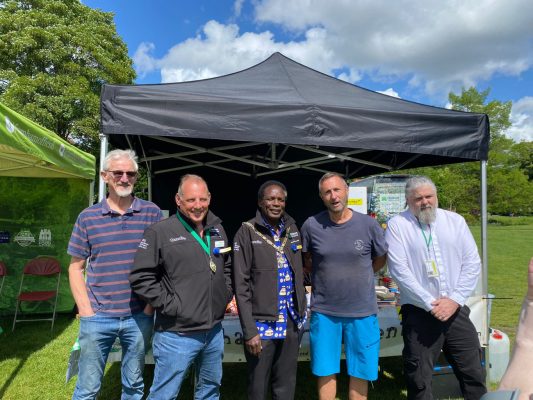 5 men standing in front of a gazebo.