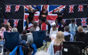 Crowd watching three dancers on a stage.