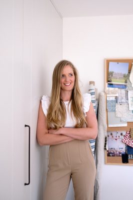 photo of a woman with her arms crossed and smiling