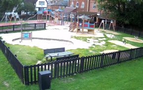 Playground with a fence around it.