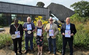 Five people holding certificates