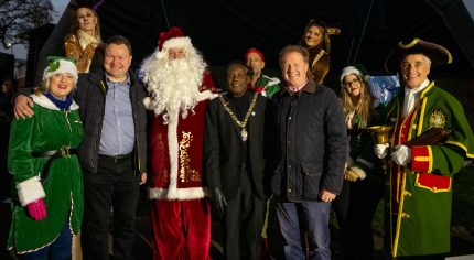 Group of people including the Mayor, Father Christmas , town crier and elves