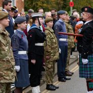 Uniformed cadets stand before parade marshall at Remembrance Sunday parade.