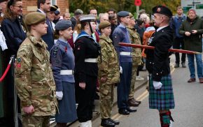 Uniformed cadets stand before parade marshall at Remembrance Sunday parade.