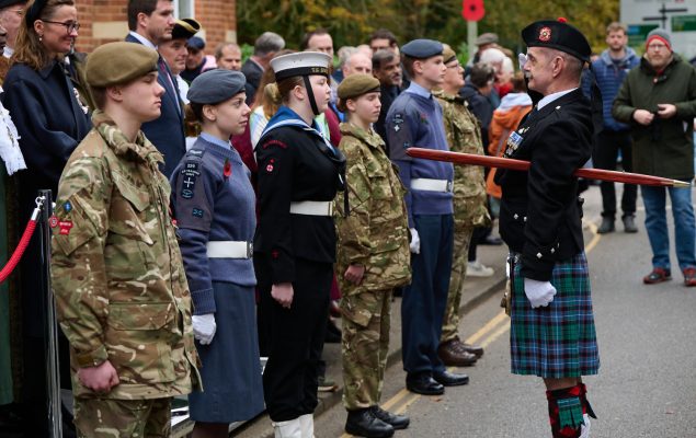 Uniformed cadets stand before parade marshall at Remembrance Sunday parade.