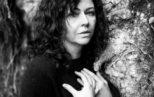 Black and white picture of a woman looking into the camera.