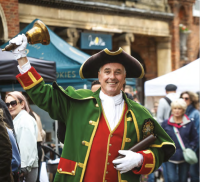 Front cover of a residents' guide showing a town crier.